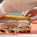 A Hook & Ladder sub includes smoked turkey breast, Virginia honey ham, and melted Monterey Jack, served with mayo, deli mustard, lettuce, tomato, onion, and a pickle on the side. Melanie Maxwell I AnnArbor.com